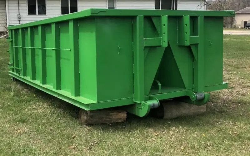 Roll-off dumpster beside a house for a cleanout